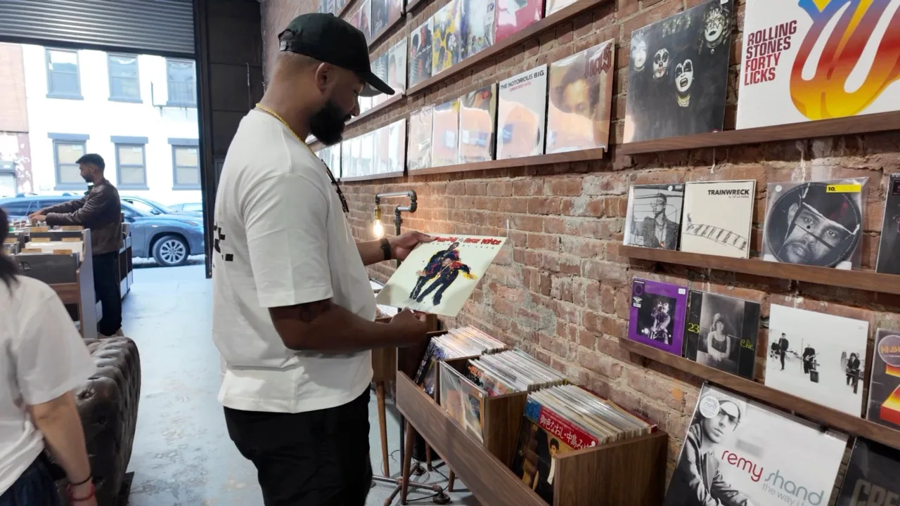 Keon browsing record bins, with close-up views of hands selecting vinyl sleeves