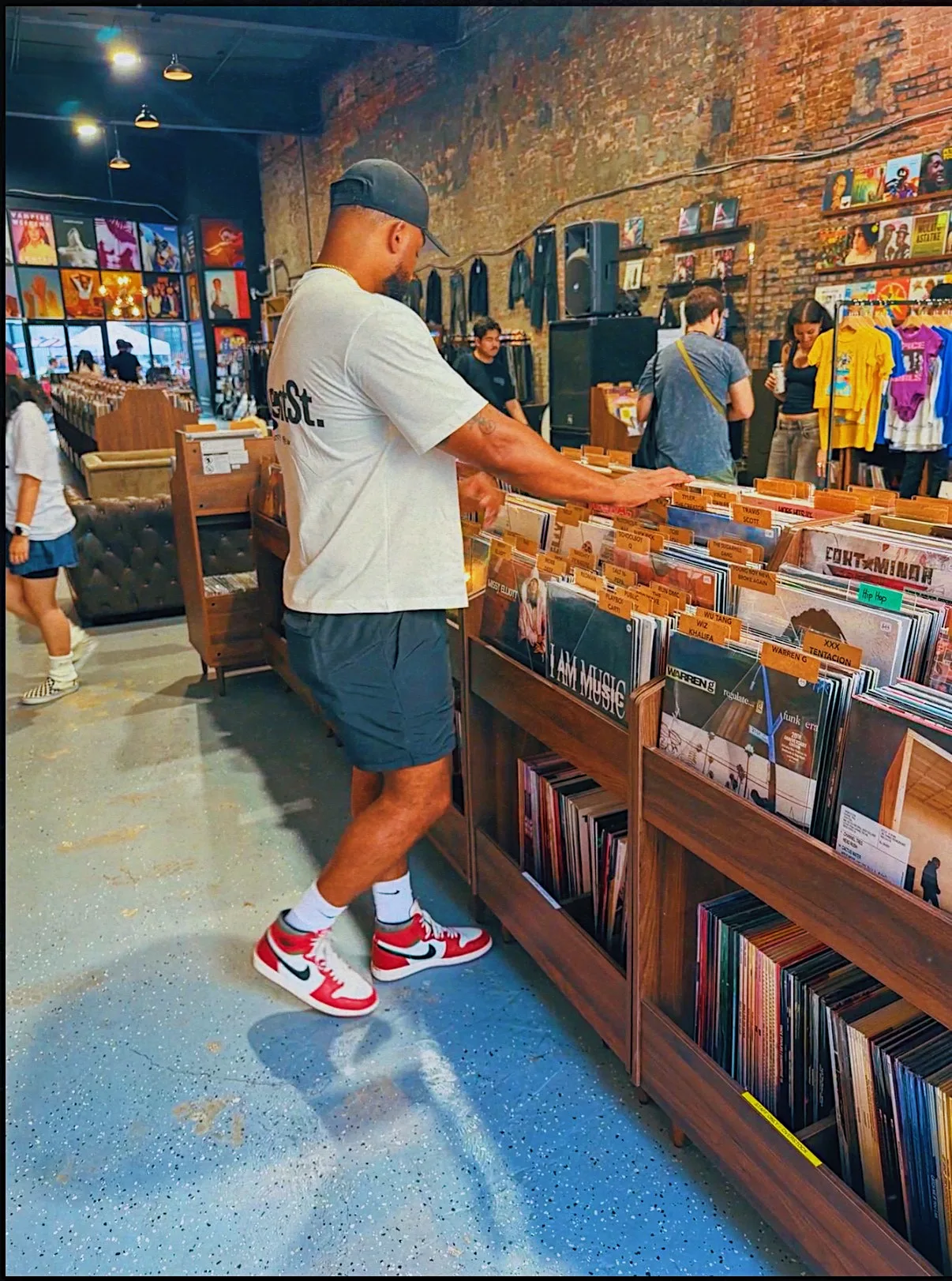 Keon NaVarr browsing vinyl records in a sunlit record store
